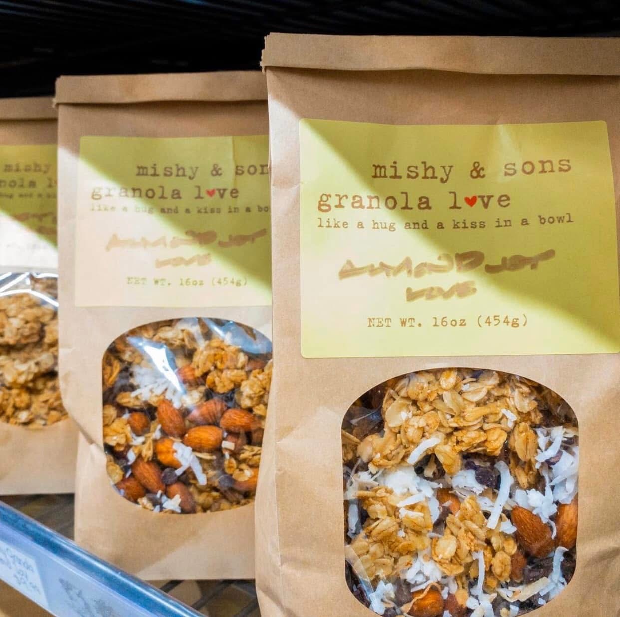 Bags of Almond Joy Love granola with almonds and coconut on a shop shelf